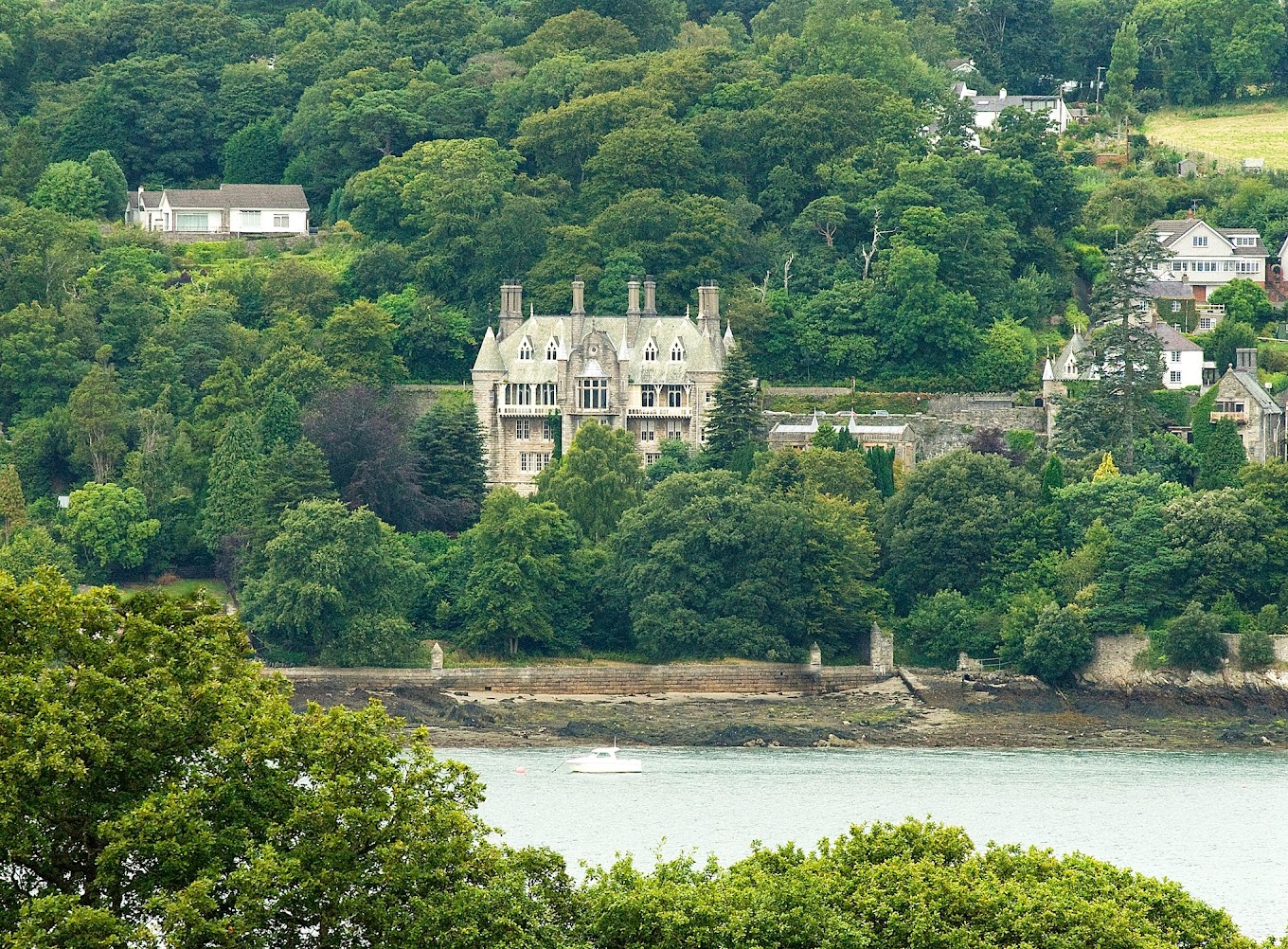 Distant view of the chateau sitting across from the menai straits